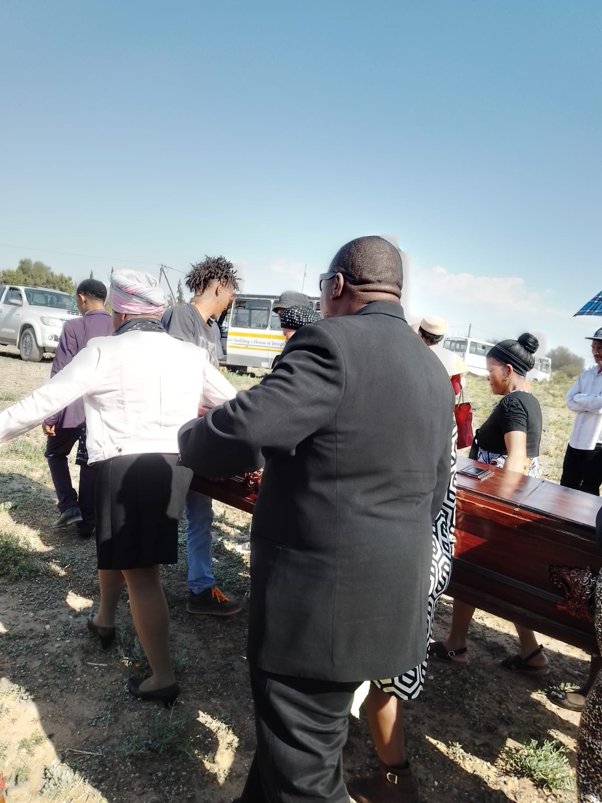 Pallbearers carrying the casket to the graveside